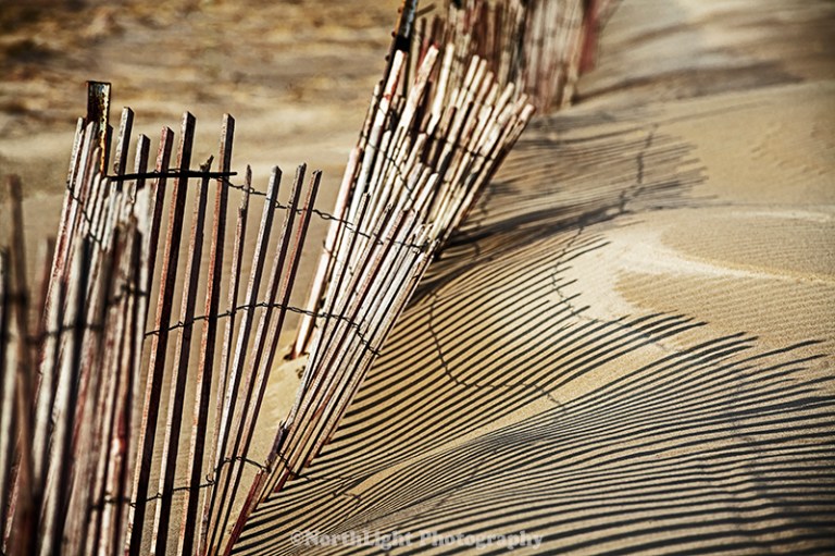 Snow fence all beach near the Ludington State Park Beach House.